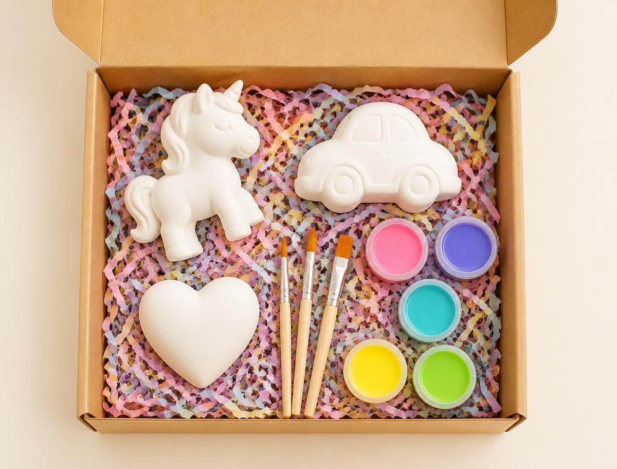 Happy Painter Box — open ceramic subscription box with unpainted figurines, brushes and paint pots